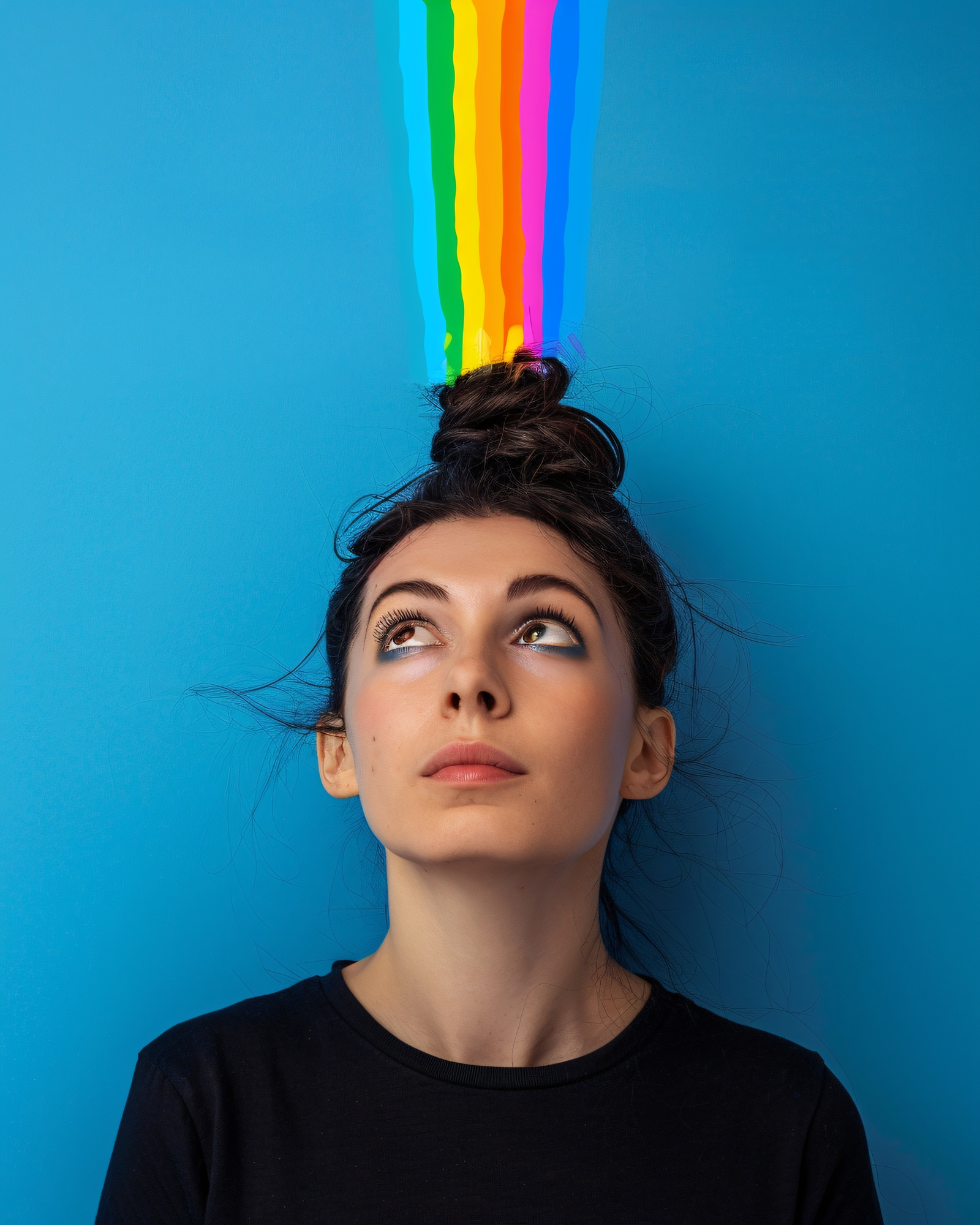 A person with makeup leaning against a light blue wall with vertical rainbow colors over their head